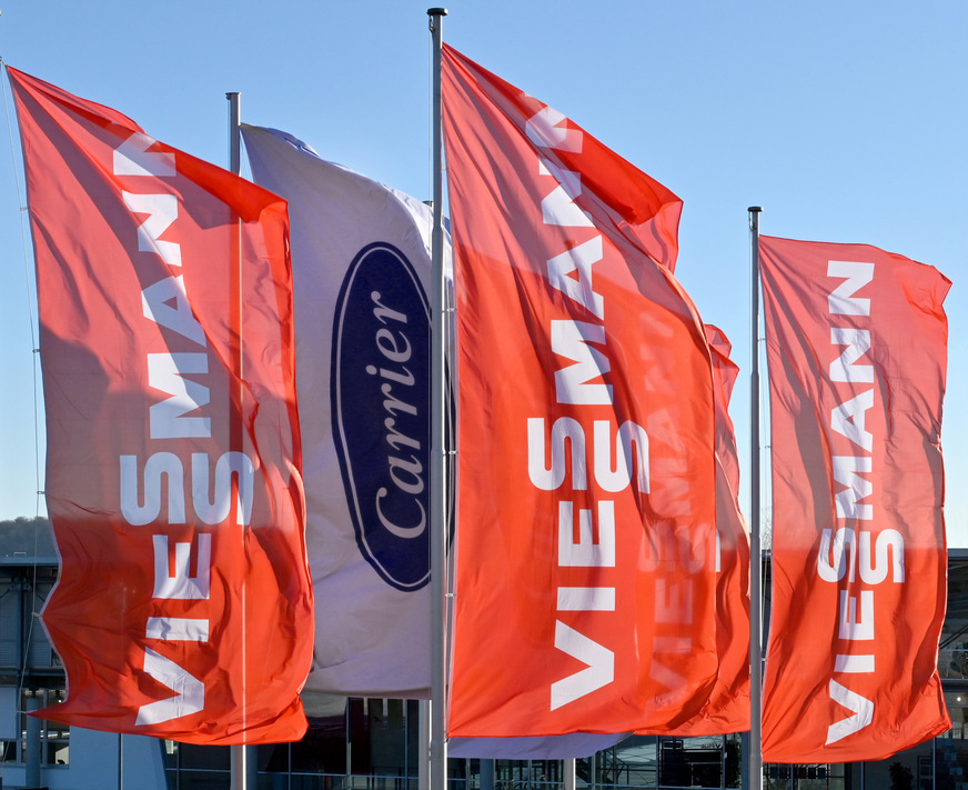 Seit dem Closing sind am Viessmann-Standort Allendorf – der gleichzeitig Headquarter der EMEA Business Unit ist – neben den orangefarbenen Viessmann-Fahnen auch Carrier-Fahnen zu sehen.