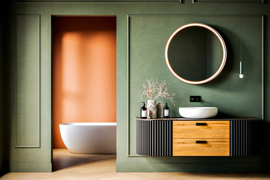 Mehr Charakter erhält ein Bad, wenn außer Materialfarbigkeit und langlebigem ­Graugrün noch ein weiterer Farbton wie hier das Terra im Hintergrund hinzukommt, um die unterschiedlichen Funktionsbereiche voneinander zu trennen.