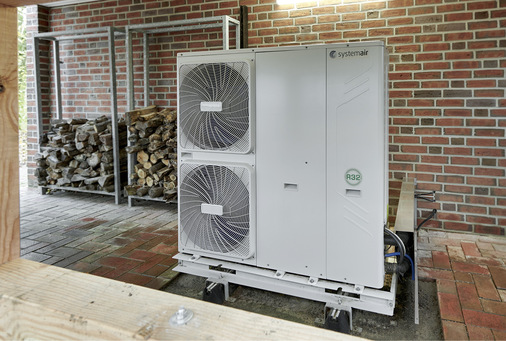  Regenerative Wärme, früher und heute: Das Kaminholz im Hintergrund wird für stimmungsvolle Abende genutzt, die Wärme- und Warmwasserversorgung wie auch die Kälteenergie liefert aber die Außeneinheit der Systemair-Wärmepumpe mit 16 kW Heizleistung.