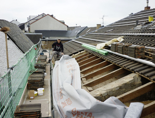 Dachreparatur mit Photovoltaik: Bei diesem Dach wurden die Sparren, die Lattung und die Eindeckung eingehend überprüft, bevor die Module installiert wurden. Vorbildlich auch das Fanggerüst am Dachtrauf. - © Priogo AG
