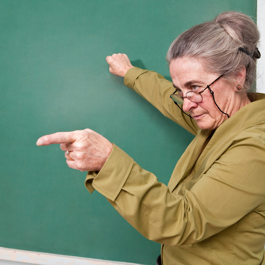 Strict teacher pointing at student