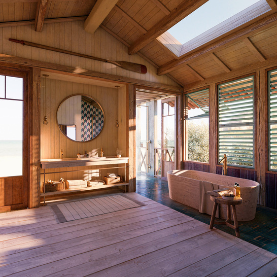 Das Badkonzept löst die Grenze zwischen dem Innenraum und den Naturelementen auf. Natürliche Materialien wie rohes Kiefernholz und Travertin prägen das Interieur, gestreift vom Sonnenlicht, das durch Faltfenster mit Holzlamellen fällt.