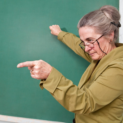 Strict teacher pointing at student