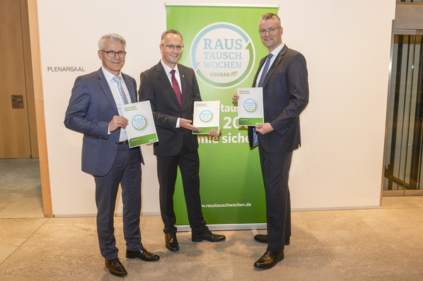 Mainova-Vorstand Dr. Constantin H. Alsheimer (rechts) übergibt im Hessischen Landtag den Ergebnisbericht der Raustauschwochen an die Abgeordneten Dirk Landau (links) und Heiko Kasseckert (Mitte).